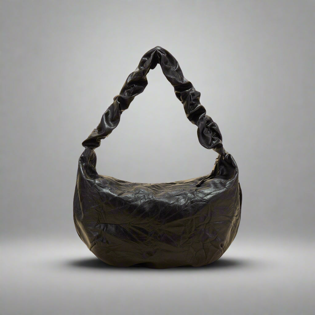 A black crescent-shaped tote bag with a luxurious leather strap and zipper closure.