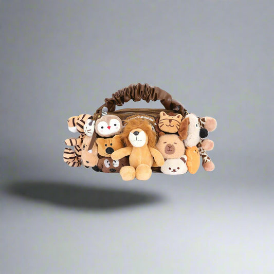 A tote bag with a variety of plush toy animals including lions, owls, tigers, dogs, cats, bears, pandas, and giraffes, spilling out from the top.