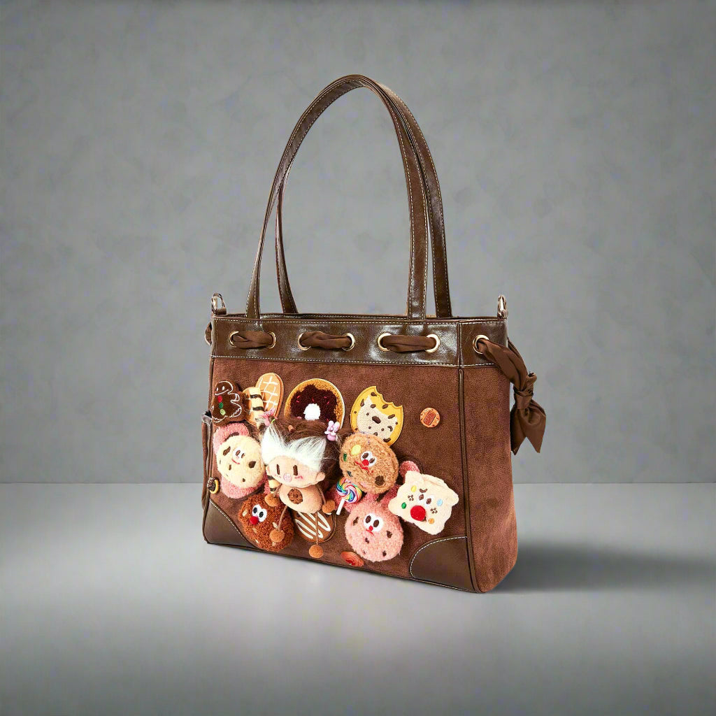 Brown handbag with decorative cookies on a white background