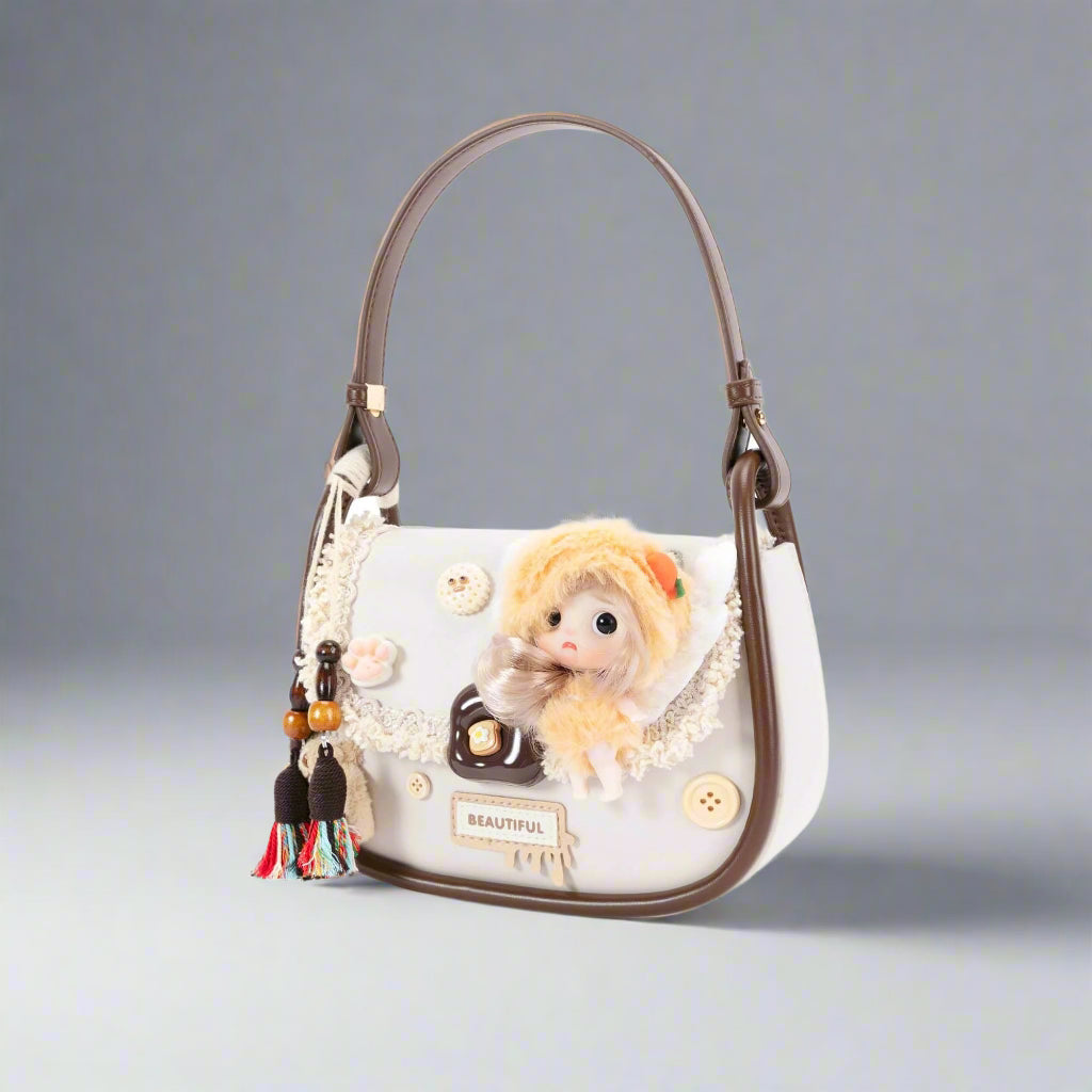 Handbag with a decorative doll and embellishments on a white background
