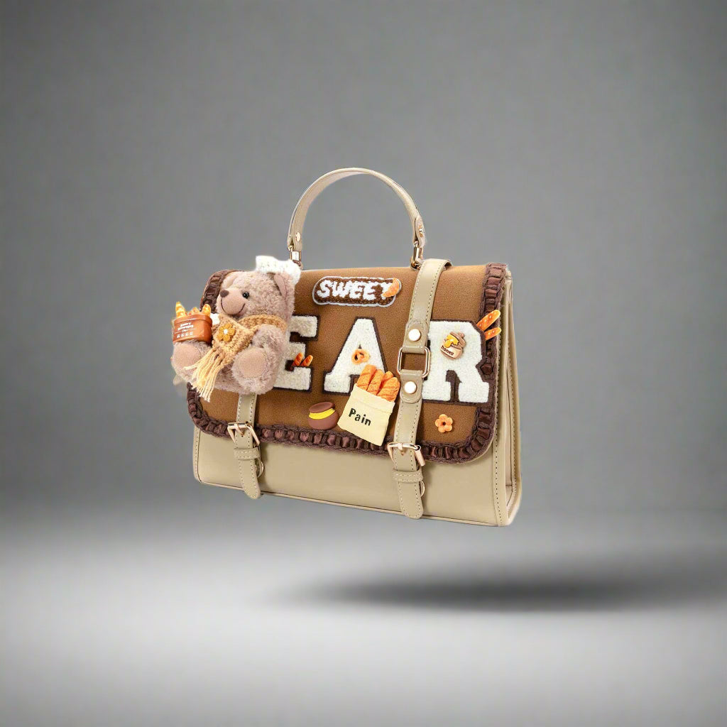 Handbag with plush toys and 'Sweet Bear' text on a white background