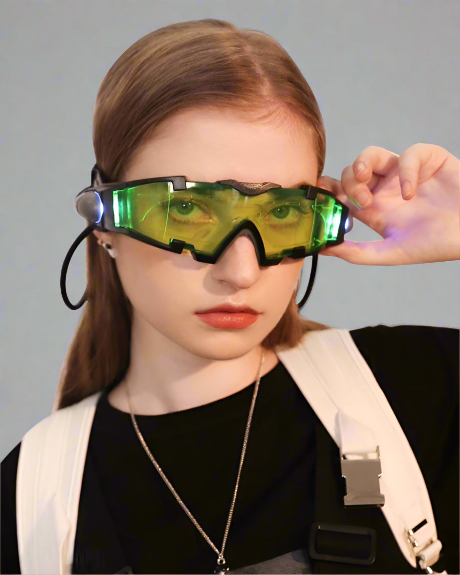 A person wearing green LED night vision goggles with a black and white outfit.